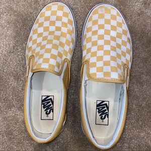 Woman’s yellow checkered slip on vans